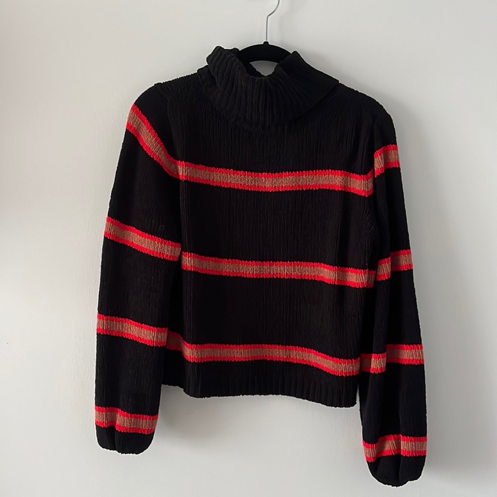 This is a 100% polyester turtleneck sweater